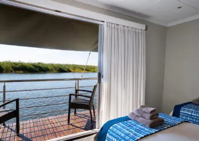 superior_cabin_top_deck_twin_bed_setup_with_outdoor__chairs-Flame of Africa