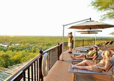 Guests-on-the-Victoria-Falls-Safari-Lodge-pool-deck-Flame of Africa